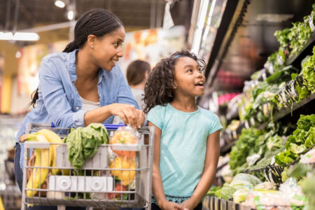 Mom and daughter shopping for produce