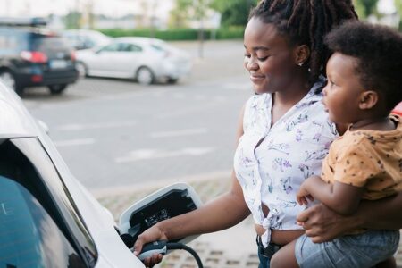 mom and child at EV charging station