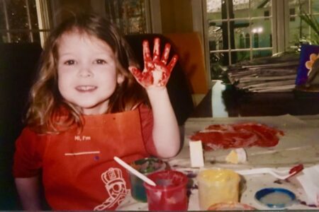 Preschooler with finger paint creating