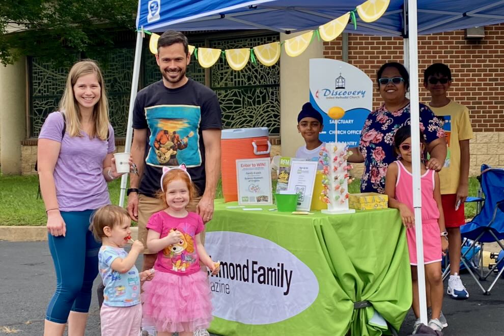 families at a LemonAid stand 