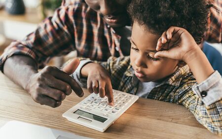 father and son with calculator