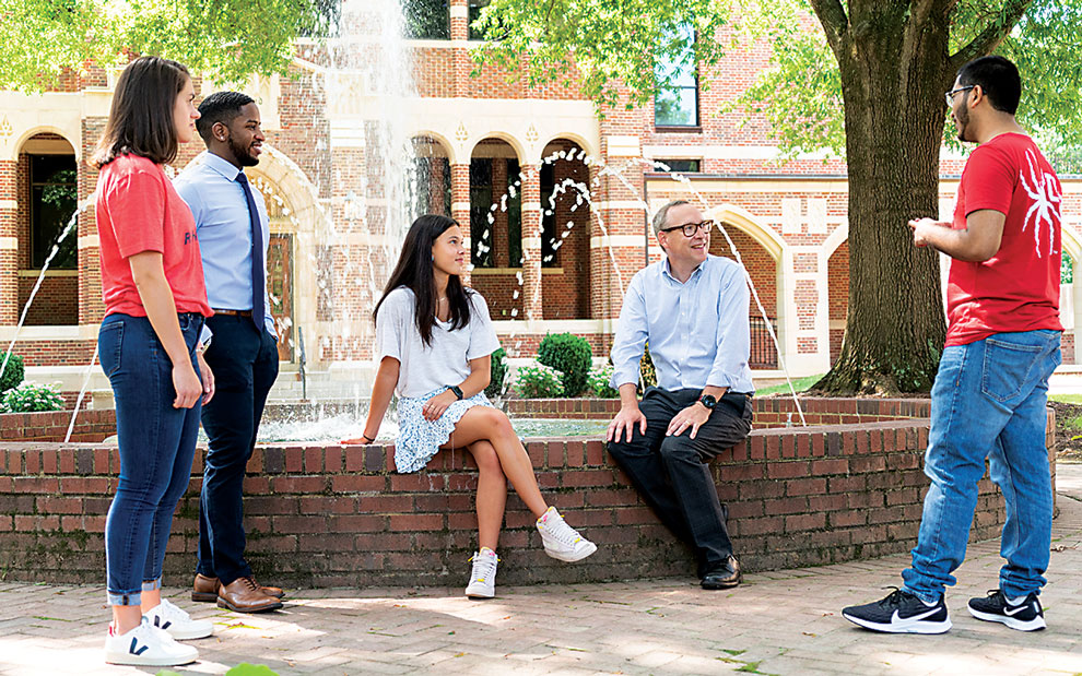 Hallock visits with students on campus outside Maryland Hall.