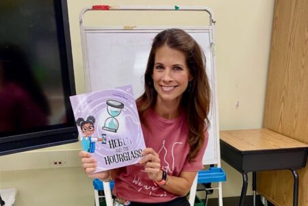 Robin Milwit holds her book Hedda and the Hourglass