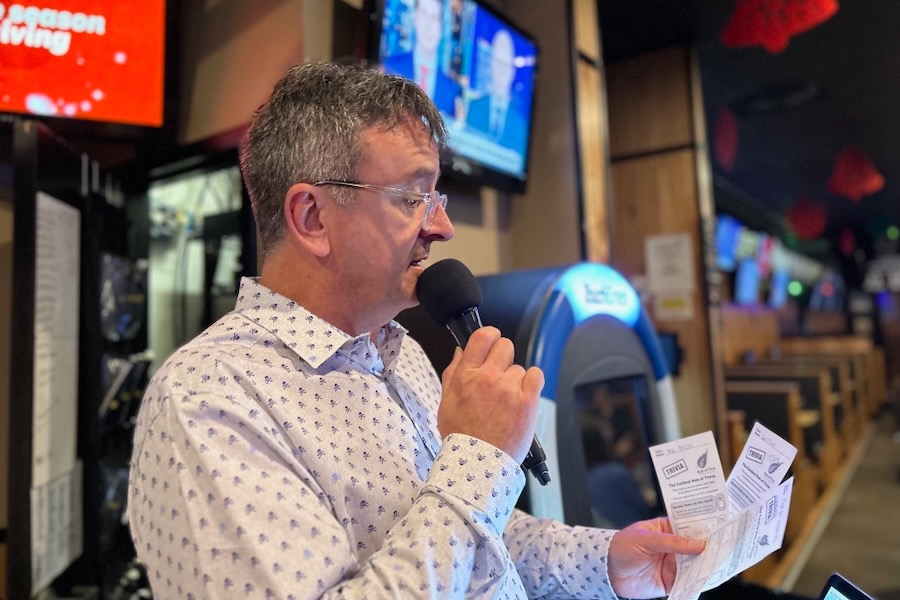 man on a microphone at a bar