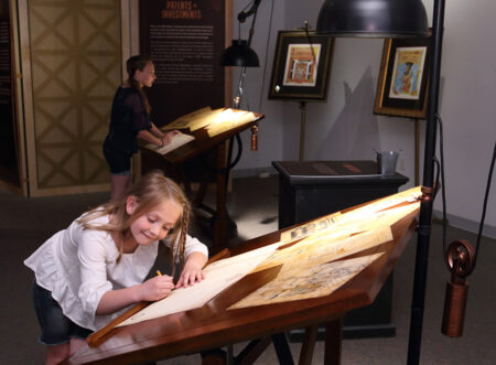 SMV _JanMatzeliger-DiscoverSteampunk -ImagineExhibitions - girl at desk