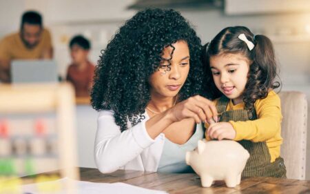 Mom and daughter with piggy bank