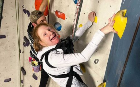 Janie climbing a rock wall