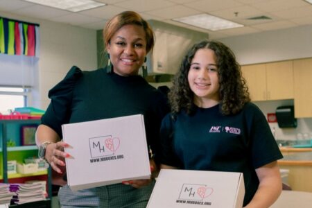 Mila fills boxes with fidget toys and other items to help girls with mental health