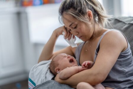 woman holding crying baby