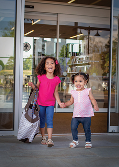 Two happy sisters leaving the library 