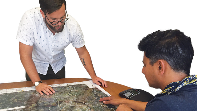 Dr. Jeremy Hoffman and another scientist review maps at Science Museum of Virginia