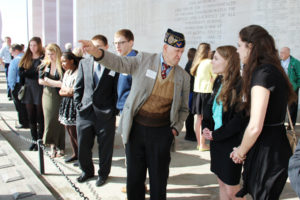 VWM Vol pointing out names on Shrine to students