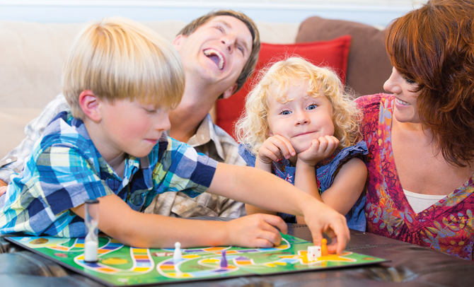 family playing board game